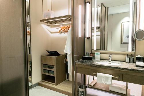 a bathroom with a sink and a mirror at Steigenberger Hotel Chongqing in Chongqing