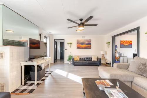 a living room with a couch and a ceiling fan at Uptown Estates - Peak Haven - Stay Explore Belong in Flagstaff