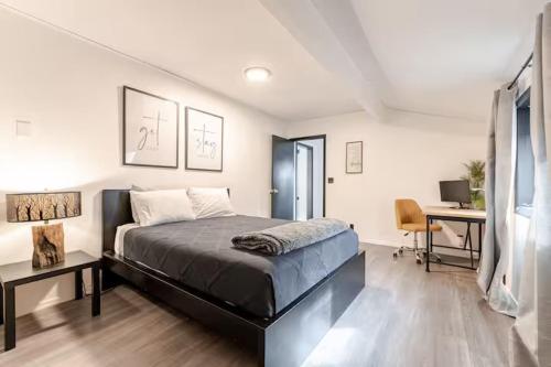 a bedroom with a bed and a desk with a computer at Uptown Estates - Peak Haven - Stay Explore Belong in Flagstaff