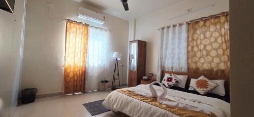 a bedroom with a bed and a large window at Sunshinee Villa in Pune