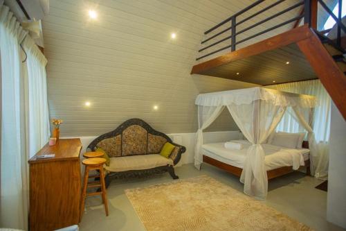 a bedroom with a bunk bed and a chair and a desk at River Bend Nook in Ahangama