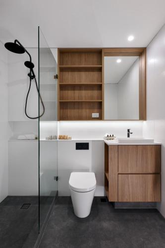 a bathroom with a toilet and a sink at Be. Fremantle in Fremantle