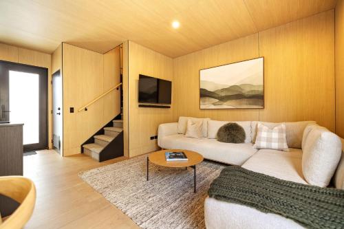 a living room with a couch and a table at Rere Villa Queenstown in Queenstown
