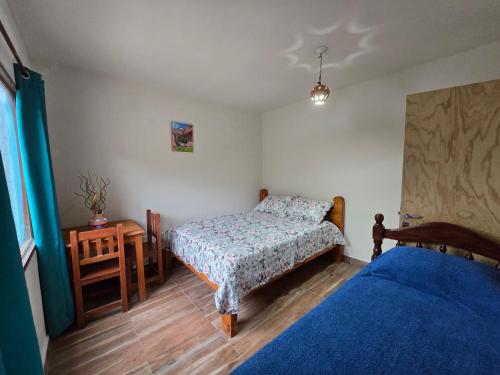 a bedroom with two beds and a night stand and a bedskirts at La Posta de Don Calixto in León