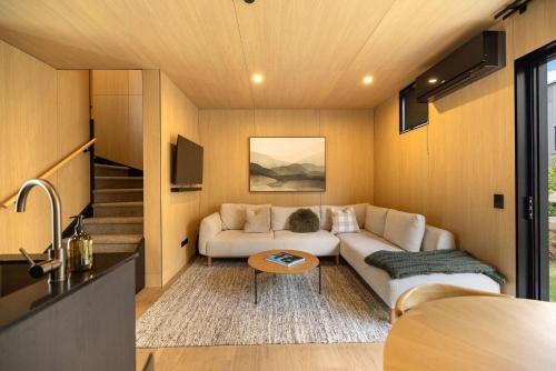 a living room with a couch and a table at Rere Villa Queenstown in Queenstown