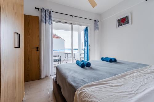 a bedroom with a bed and a view of the ocean at Seaview Sanctuary House in Larnaca