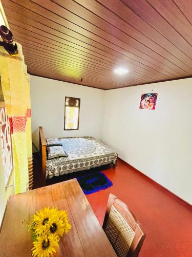 a room with a bed and a table in it at Zandeepa Homestay in Ahungalla