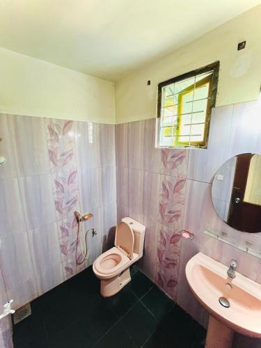 a bathroom with a toilet and a sink at Zandeepa Homestay in Ahungalla