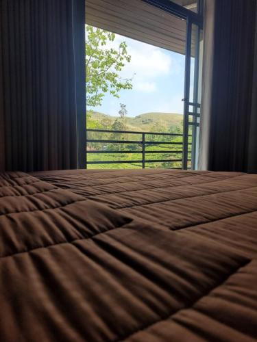 a bedroom with a bed and a window with a view at Hatton Nottingham Villa in Hatton