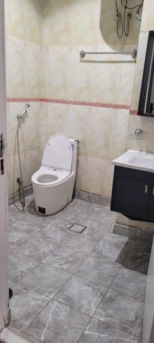 a bathroom with a toilet and a sink at سهول بارك in Riyadh