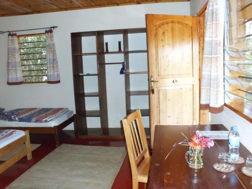 a room with a table and a chair and a dining room at Meru Mbega Lodge in Usa River