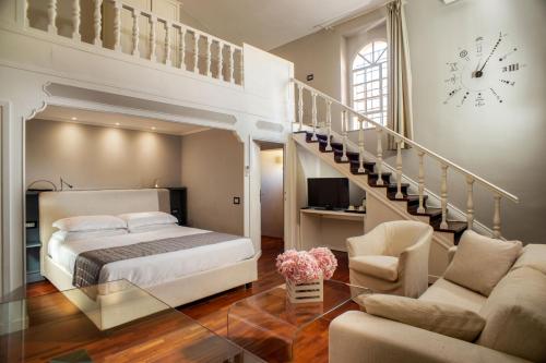 a bedroom with a bed and a staircase and a clock at Les Fleurs Luxury House in Rome