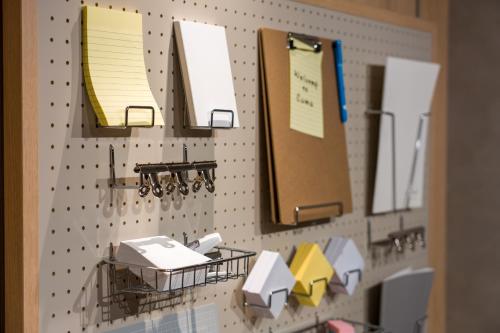 a wall with papers and paper dispensers on it at Sumu Ueno East in Tokyo