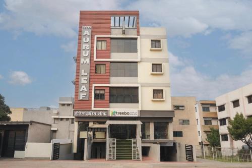 a tall building with a sign on it at Treebo Aurum Leaf in Nagpur