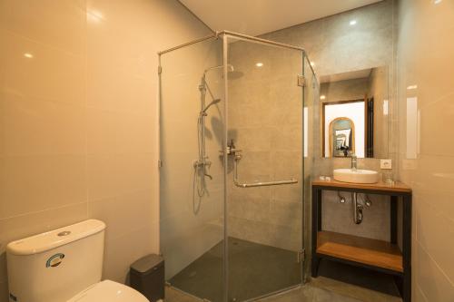 a bathroom with a shower and a toilet and a sink at Amantra Ubud in Ubud