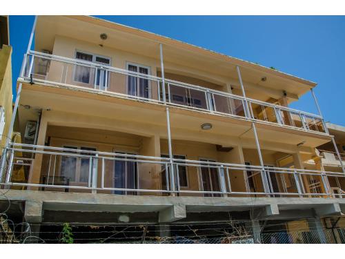 a large yellow building with balconies on it at Bano Beach Residence - Grand Bay Beach in Grand Baie