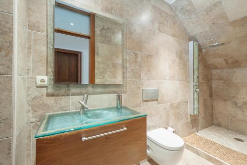 a bathroom with a sink and a toilet and a mirror at Cas Peix in Sa Pobla