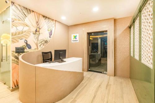 a lobby with a desk with a chair in it at Treebo Aurum Leaf in Nagpur