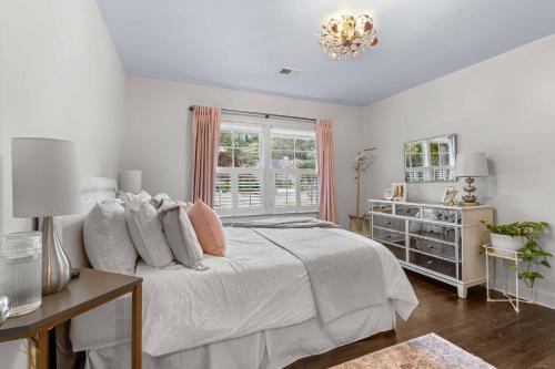 a white bedroom with a bed and a window at Private Compound in Decatur in Decatur