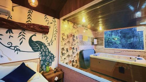 a bathroom with a tub and a large window at Pepper Valley Resort in Kalpetta