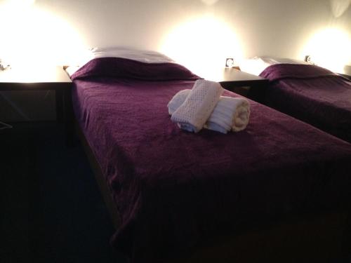 two beds in a hotel room with towels on them at Holiday home with private parking Vukovar in Vukovar