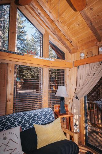 a room with a bed and a window in a cabin at Near Ski, Beaches, Pet Friendly, Full kitchen in South Lake Tahoe