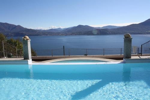 a large swimming pool with a view of a lake at Residence Il Vigneto in Oggebbio