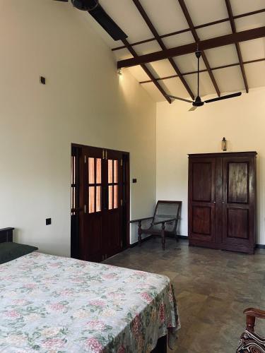 a bedroom with a bed and a chair in a room at RailNest in Talpe