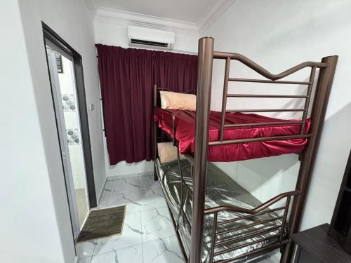 a bunk bed in a room with a mirror at Student Homestay in Kampong Ru Sepuloh
