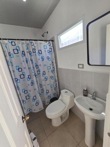 a bathroom with a toilet and a sink at Candy House Marsella in Sitio Grande