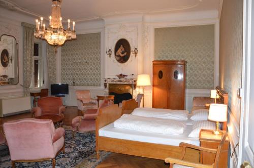 a bedroom with a bed and a living room at De l'Europe Gastein in Bad Gastein