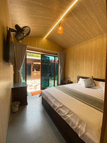 a bedroom with a large bed and a window at Your Home in Vũ Lâm