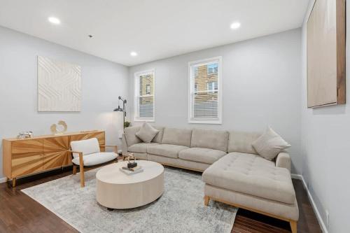 a living room with a couch and a table at Spacious 3BR 2BA Apt with Private Parking Walk to PATH in Jersey City