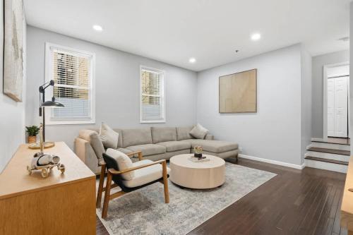 a living room with a couch and a table at Spacious 3BR 2BA Apt with Private Parking Walk to PATH in Jersey City