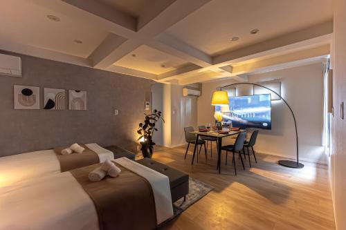 a hotel room with a bed and a dining room at 15 min Shinjuku ! Kitchen,Laundry! Perfect for a Long Stay I many facilities nearby I Shinjuku,Tokyo in Tokyo