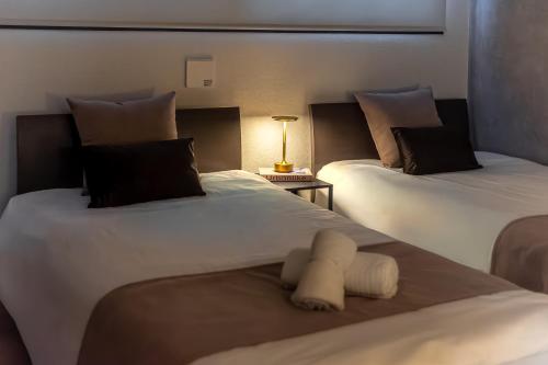 two beds sitting next to each other in a room at 15 min Shinjuku ! Kitchen,Laundry! Perfect for a Long Stay I many facilities nearby I Shinjuku,Tokyo in Tokyo