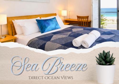 a bedroom with a bed with towels on it at Sea Breeze Apartment - Direct Ocean Views - Top Floor in Perth