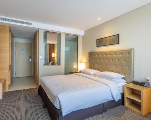a bedroom with a large bed in a hotel room at Best Western Hotel Gunsan in Gunsan-si