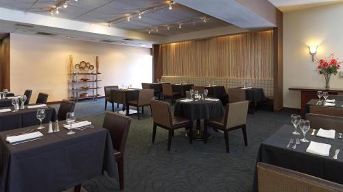 a dining room with tables and chairs in a room at Ontario Airport Hotel & Conference Center in Ontario