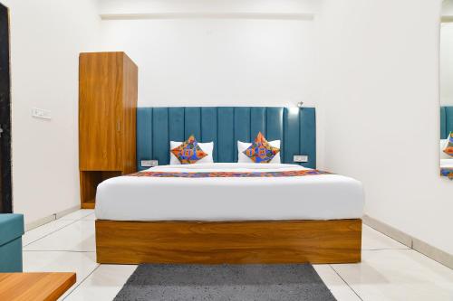 a bedroom with a large bed in a room at FabHotel Olive Inn in Indore
