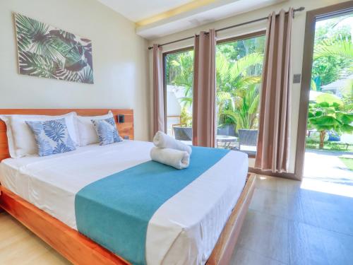a bedroom with a bed with a teddy bear on it at OHANA, Panglao Resort. in Panglao Island