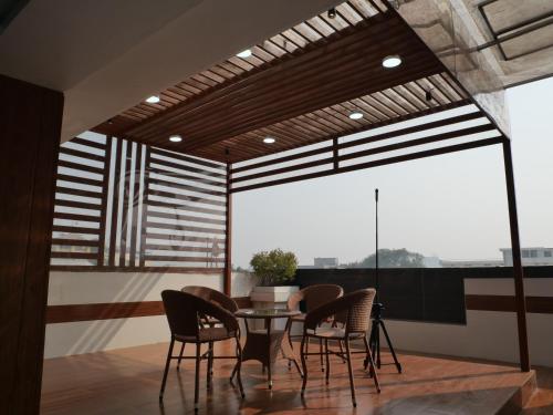 a dining room with a table and chairs at Happy Residency in Patna