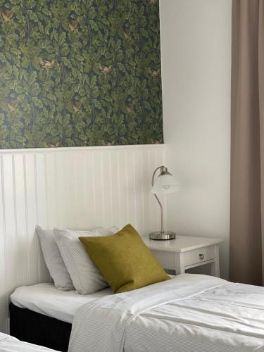 a bedroom with a bed with a green painting on the wall at Gästisbacken in Alfta