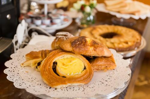 a plate of pastries and pretzels on a table at Affreschi Su Roma Luxury B&B in Rome