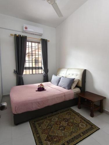 a bedroom with a bed and a table and a window at FAs KLIA Guesthouse, 4BR 4 AC , NEAR KLIA, NILAI in Sepang