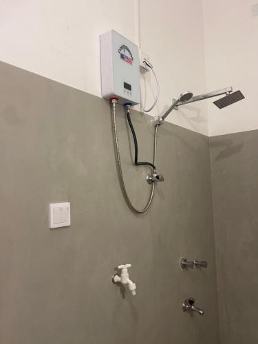 a shower in a public bathroom with a shower at Dew home stay in Dickwella