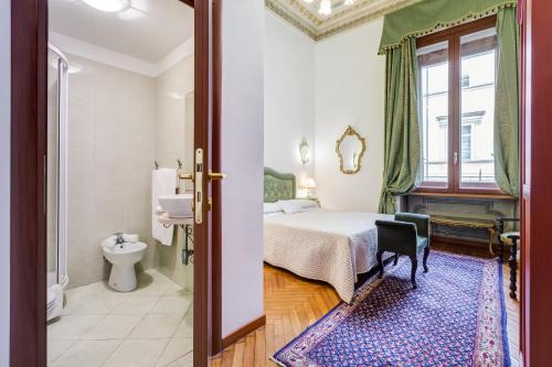 a hotel room with a bed and a bathroom at Affreschi Su Roma Luxury B&B in Rome