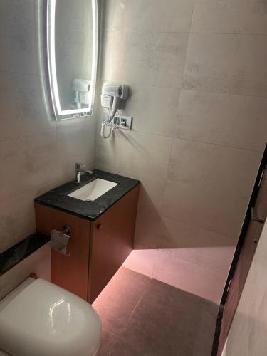 a small bathroom with a toilet and a sink at Private Studio Apartments with Balcony in New Kalyani Nagar in Pune