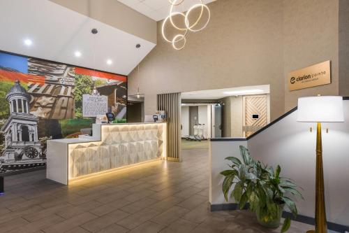 a lobby with a waiting area with a lamp at Clarion Pointe Sevierville-Pigeon Forge in Sevierville