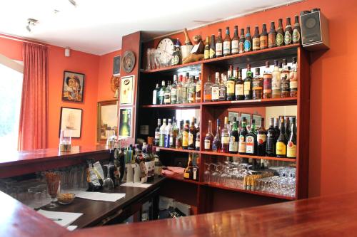 a bar filled with lots of bottles of alcohol at Medio Apartments in Fredericia